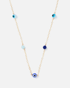 evil eye and blue gemstones on a gold chain