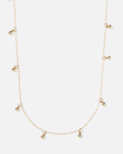 Load image into Gallery viewer, small gold ball charms hanging off of gold necklace