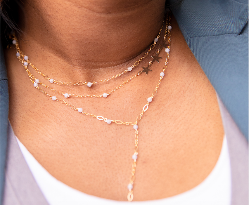 beaded necklace stacked with two other necklaces on girl