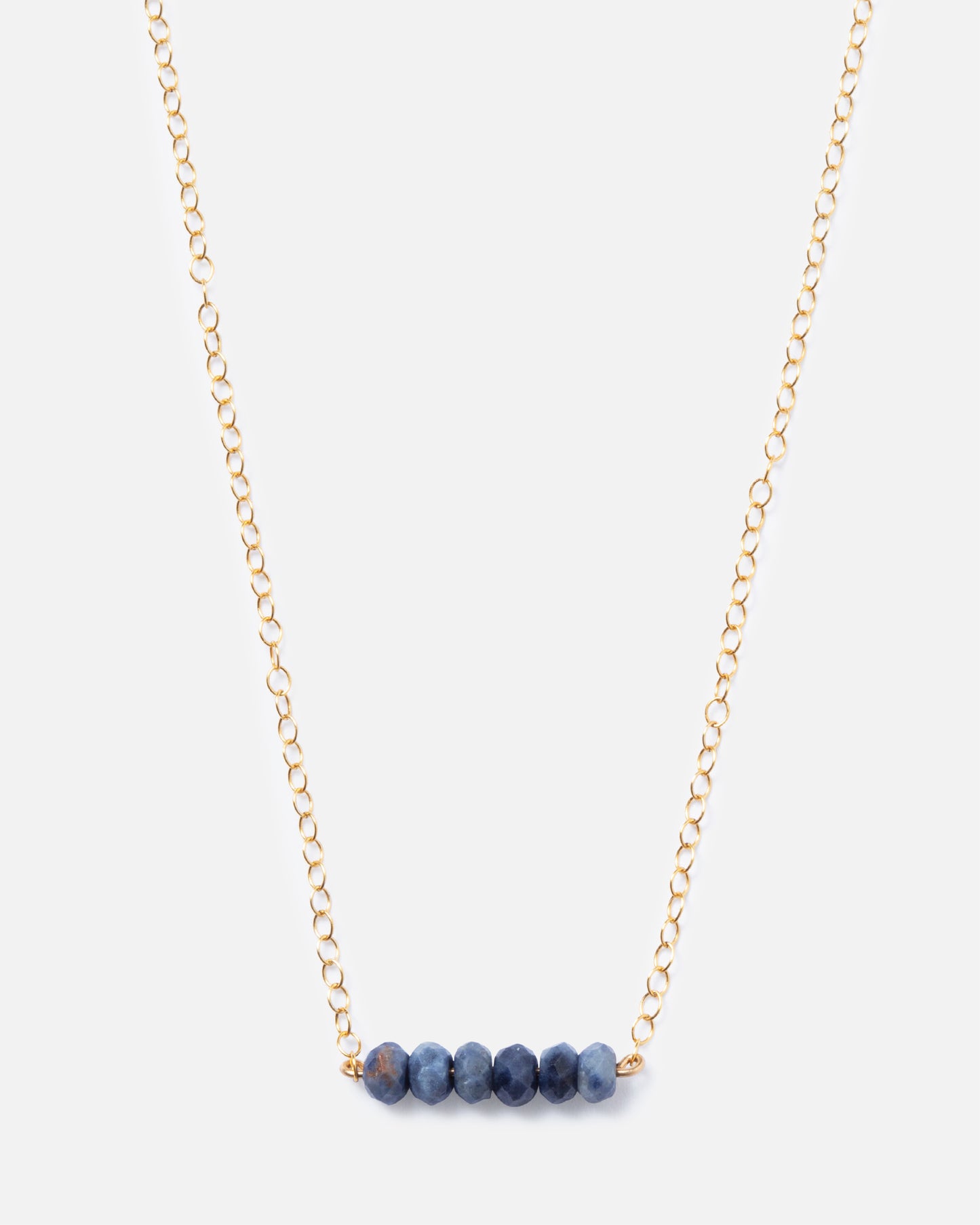 6 sapphire gemstones on a gold necklace