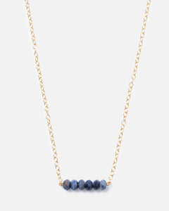 6 sapphire gemstones on a gold necklace