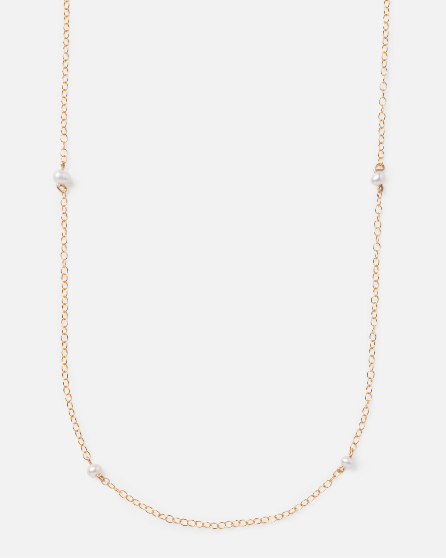 pearl beads on a long gold chain