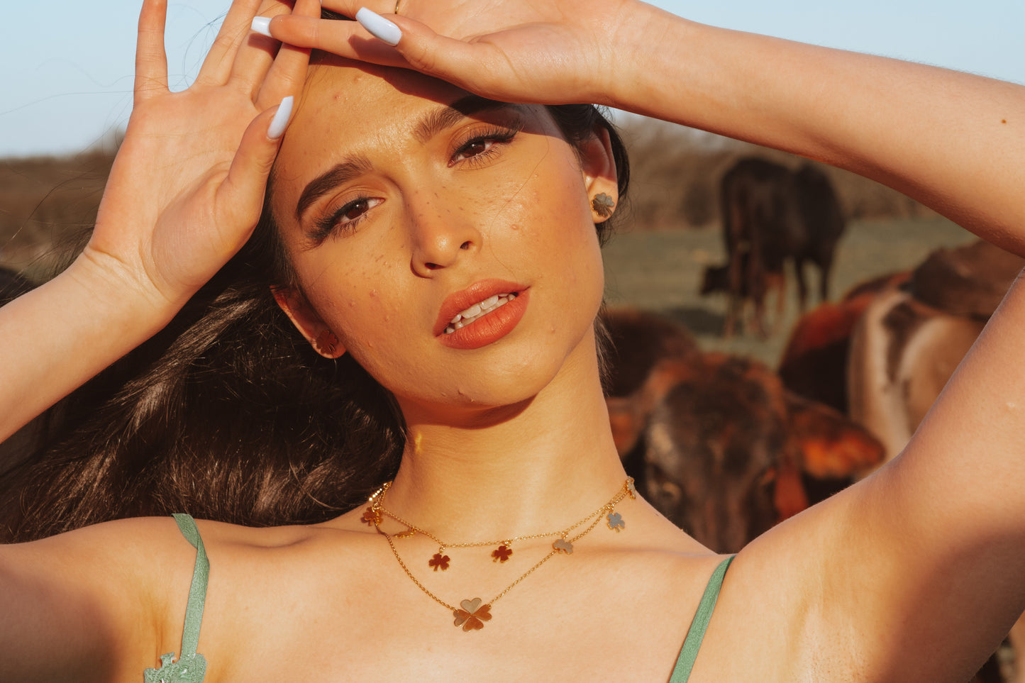 gold clover necklace on model