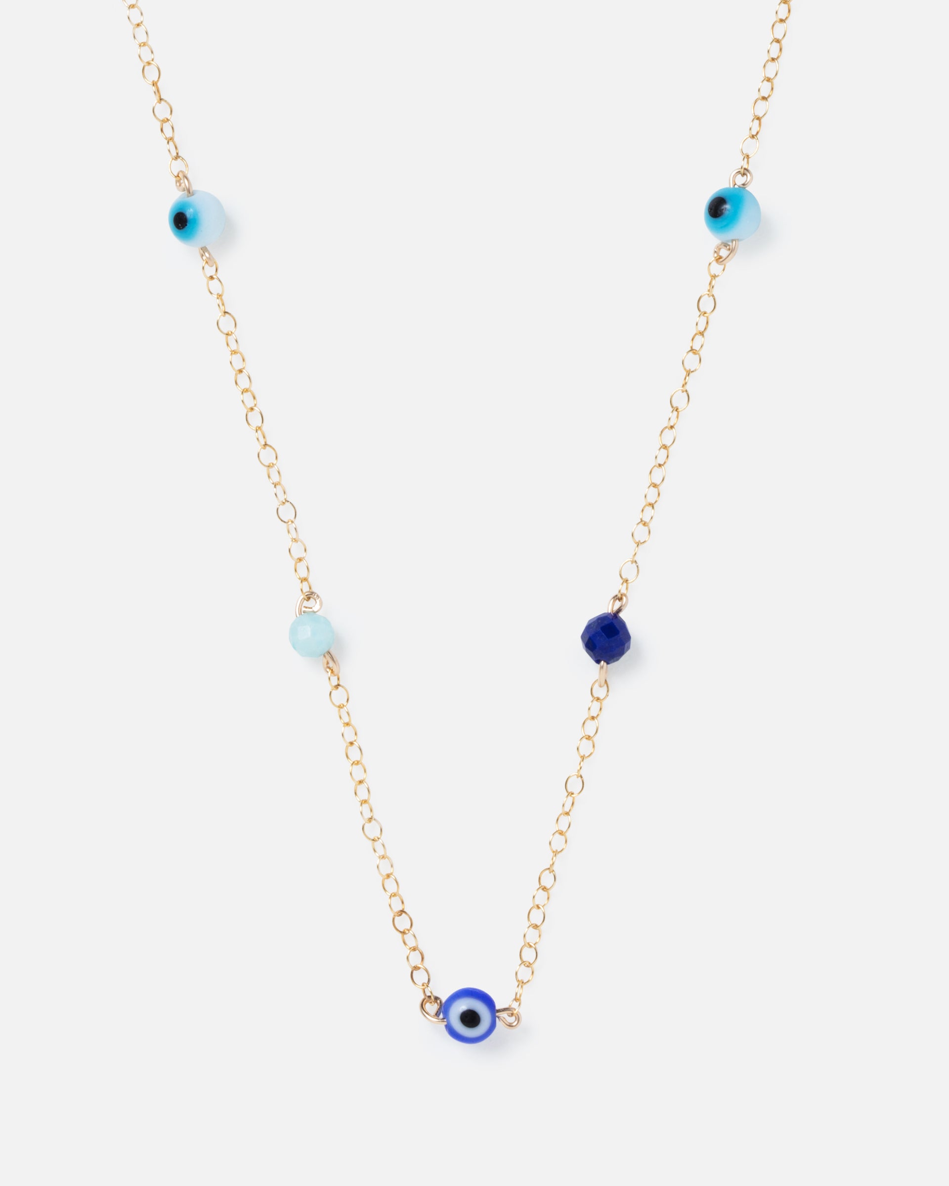 evil eye and blue gemstones on a gold chain
