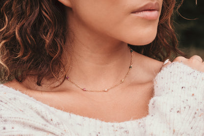 girl wearing gold necklace
