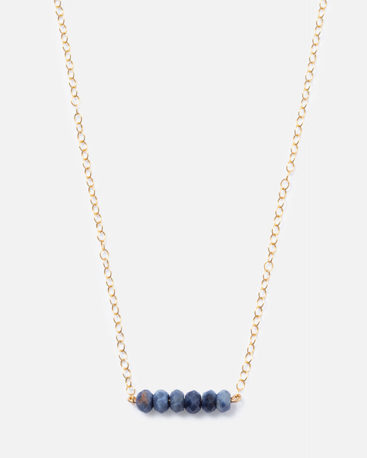 6 sapphire gemstones on a gold necklace